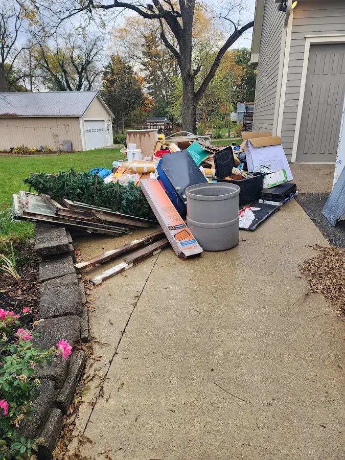 Dumpster being loaded with debris for Estate Cleanout Dumpster Rental in Hinesville